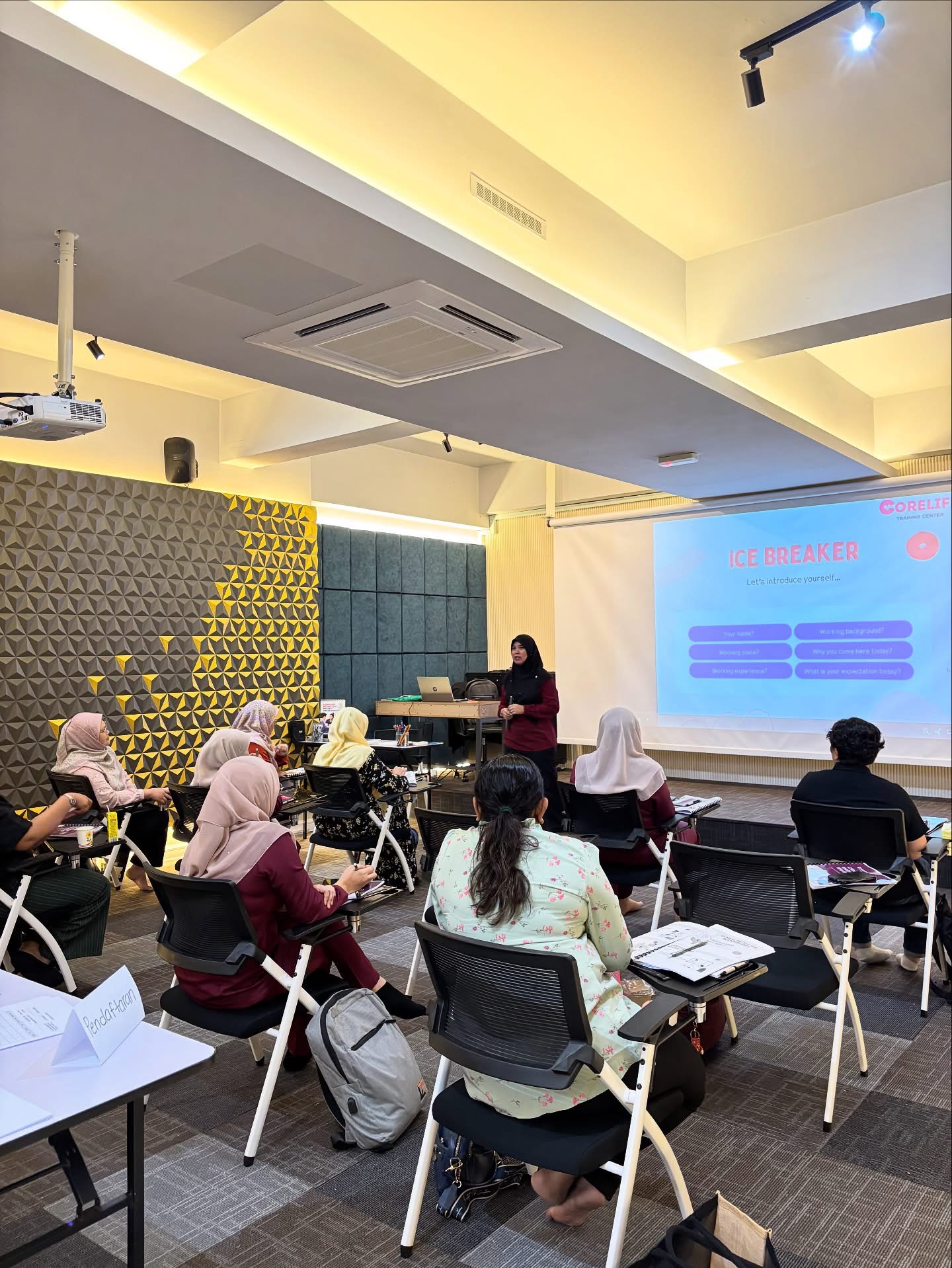 CoreLife facilitator presenting at the front of a training room.